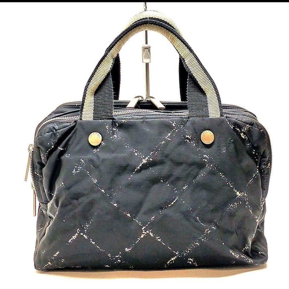 CHANEL Cream and Black Travel Bag with Elegant Design